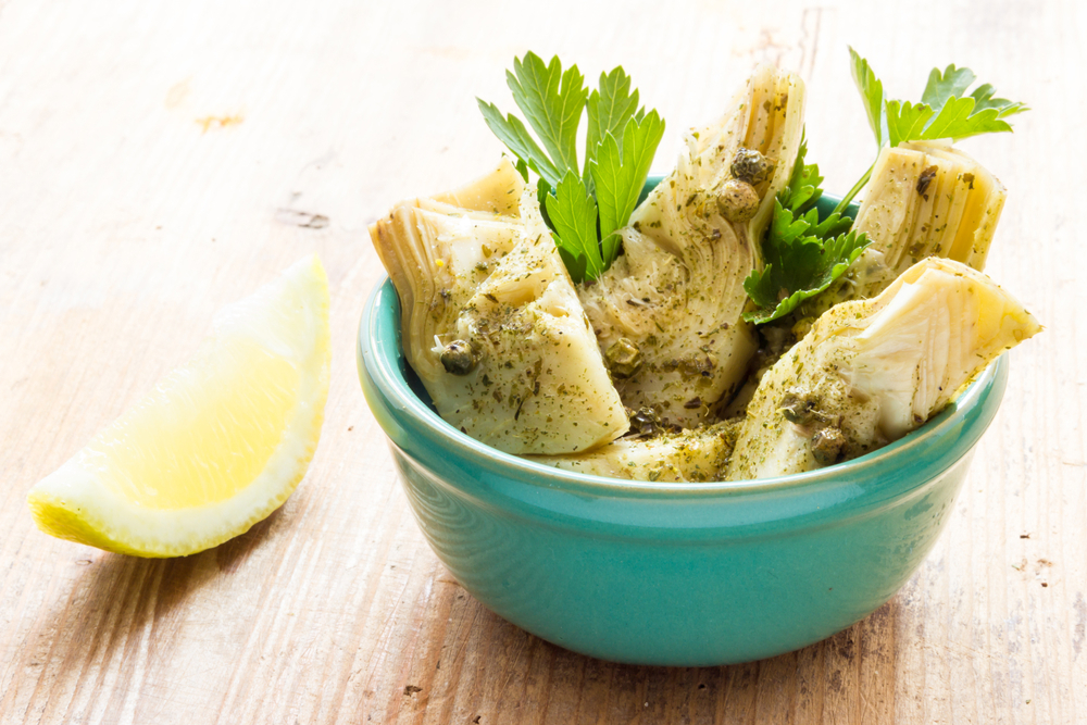  A bowl of marinated chopped artichoke hearts.