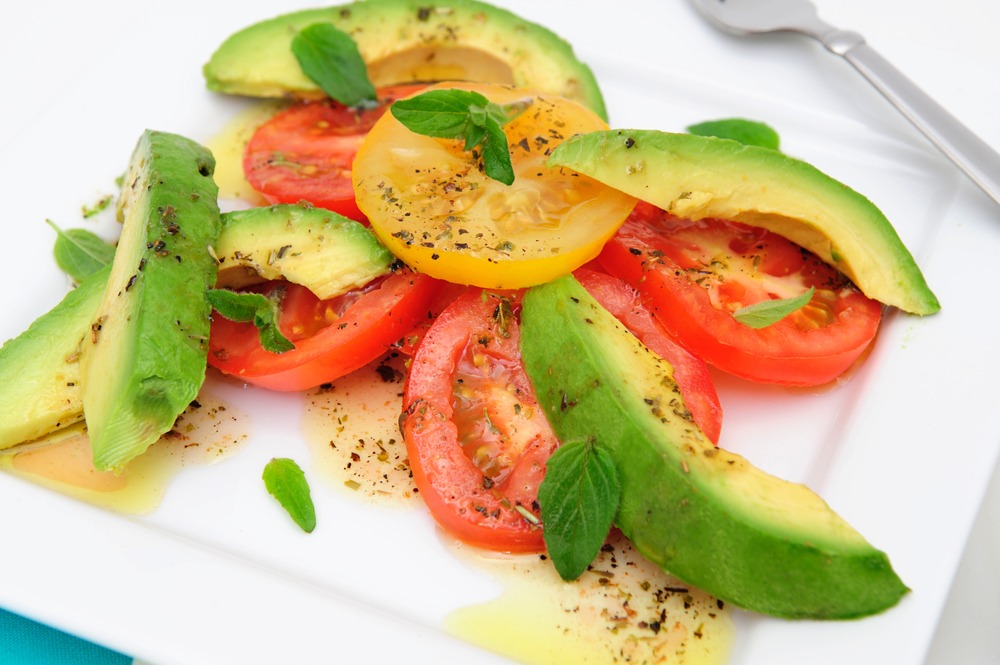 Simple salad of sliced tomatoes and avocado.