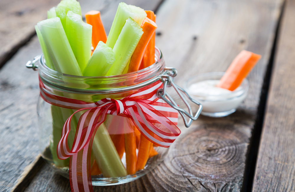 Small jar of celery and carrot sticks.