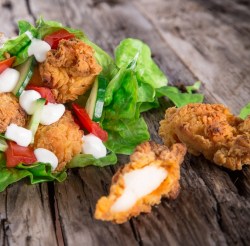 A tasty combination of Personal Trainer Food Buffalo Chicken Sticks and blue cheese wrapped in lettuce.