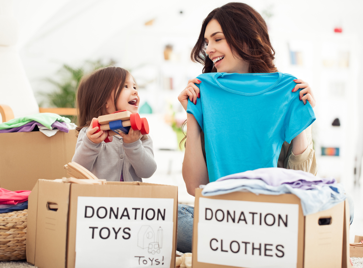 Mother and daughter preparing toys and clothes to donate for charity using their PTF box and the Givebackbox program.