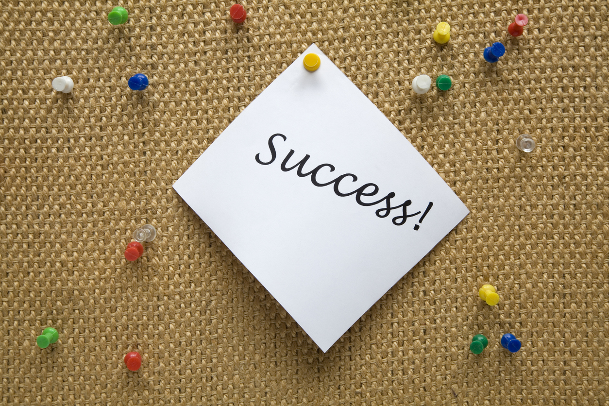 Note pinned on a foam office bulletin board with push pins all around.