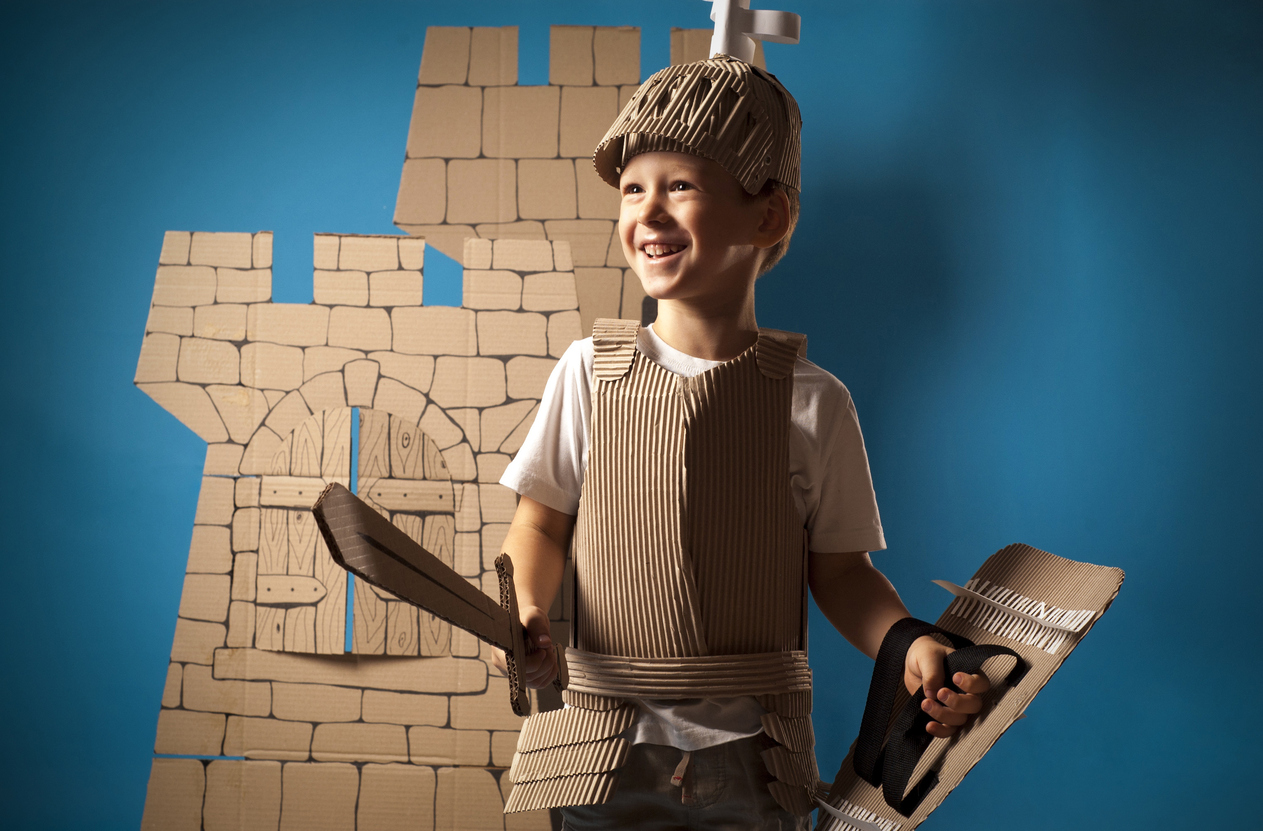 Photo of the boy in medieval knight costume made of cardboards.