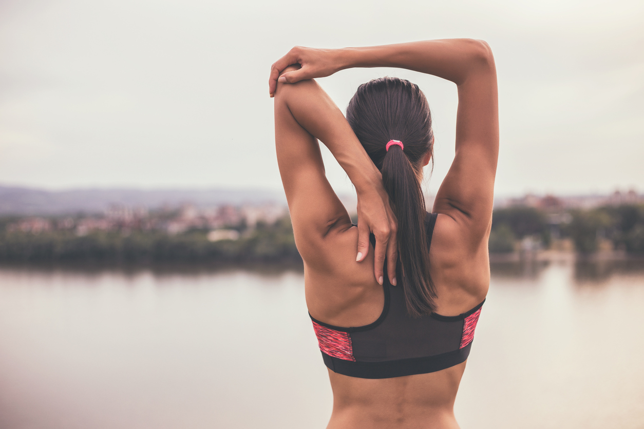 Woman stretching and exercising outdoor.