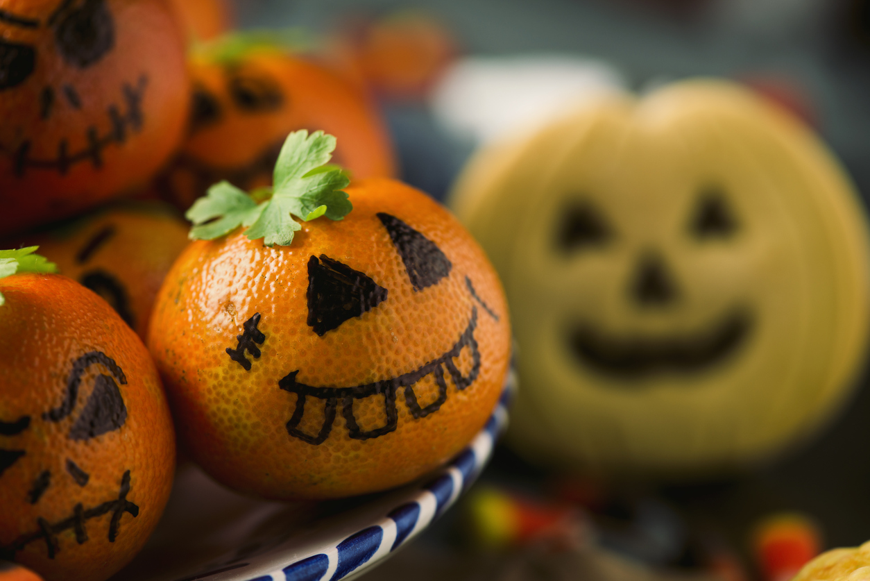 There's no need to slave over healthy Halloween treats; just grab a sharpie and draw whimsical faces on some tangerines for healthy snacks.