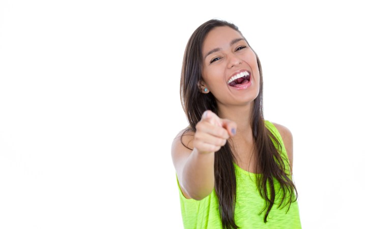 Surprise! Girl points finger and laughs after her prank is played.