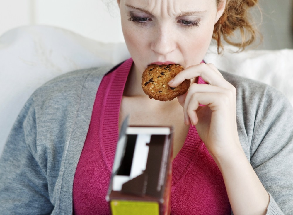 A woman eating a cookie reads the nutrition facts panel. Will she lose weight?