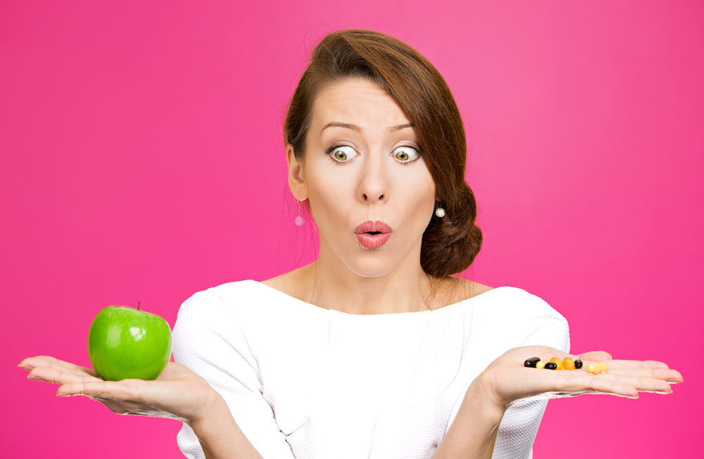 A woman is confused by the noise of commercials. Should she eat the apple or take the diet pills?