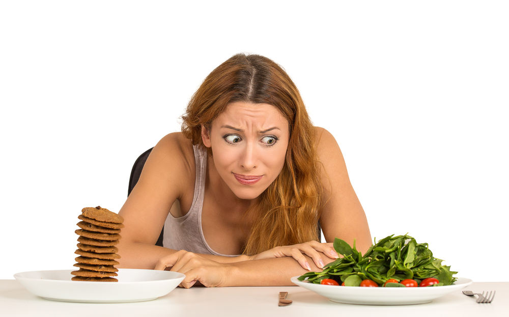 A woman trying to decide if the salad or the cookie diet is right for her.