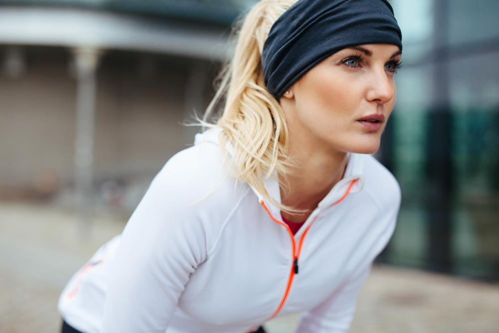 A determined-looking woman in sports gear is set to reach her goals.