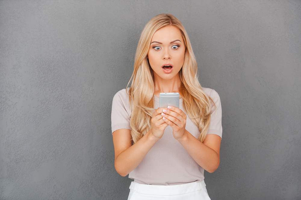 A girl is in shock as she watches a video about the newest (and grossest) on her phone. 