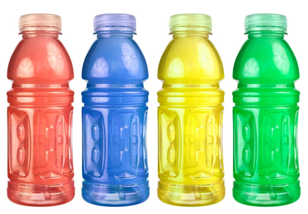 Four colorful and expensive bottles of sugary sports drinks.